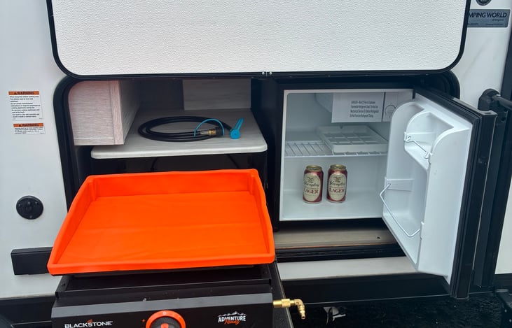 Outdoor blackstone griddle and second refrigerator to keep those extra refreshing beverages ice cold!  And outside griddle is a great tool to help you make the perfect smash burger!