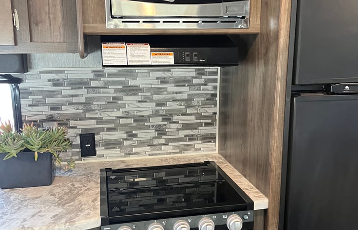 Three burner stove, oven, and microwave. Microwave only works if you are plugged in to a power source (generator of rv park hookups).