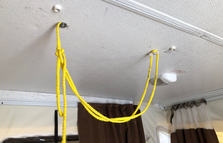one of the factory stow hooks for the door has broken, so we've improvised with a bit or rope.