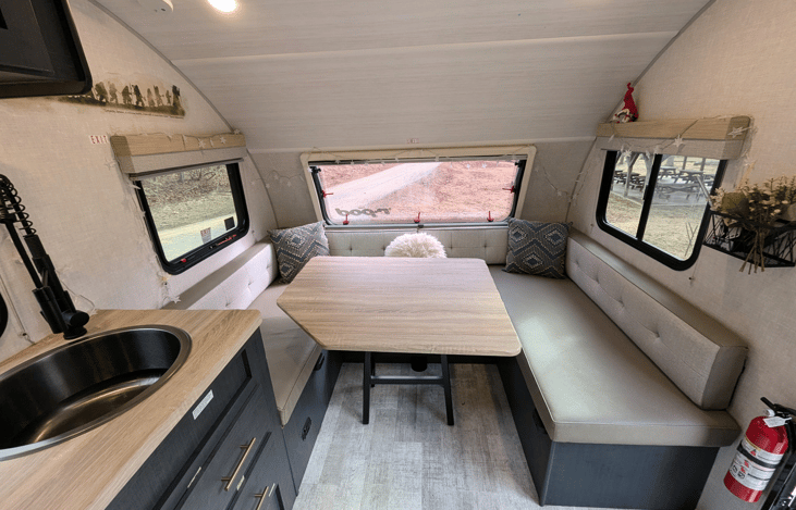 Cozy, modern and bright living area with well-equipped kitchen, TV, large dinette that converts to a bed, pop-out window and whimsical touches throughout.