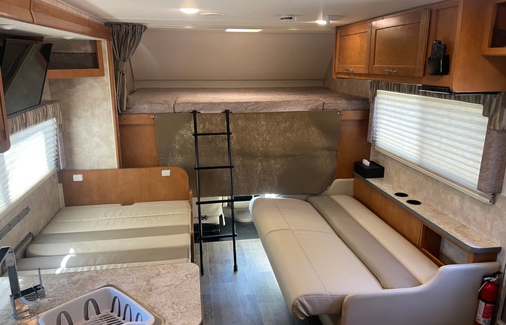 Overhead Bunk Will Comfortably Sleep 2 Adults, and  Has a Privacy Curtan.