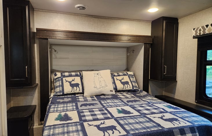 Queen sized bed with power plugs on both sides