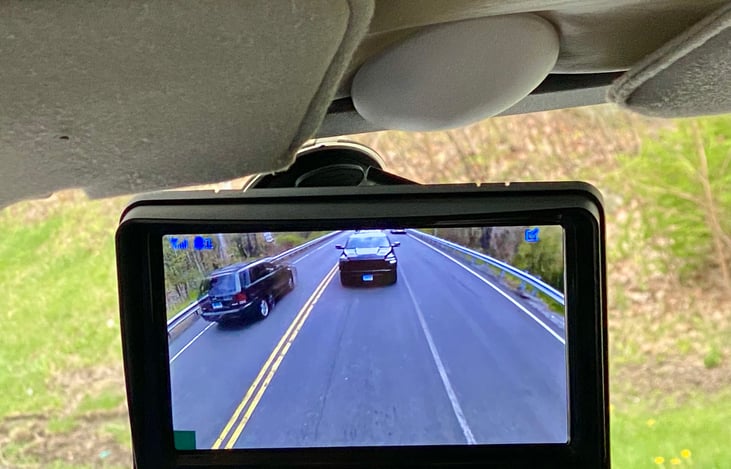 Windshield mounted rear view camera monitor