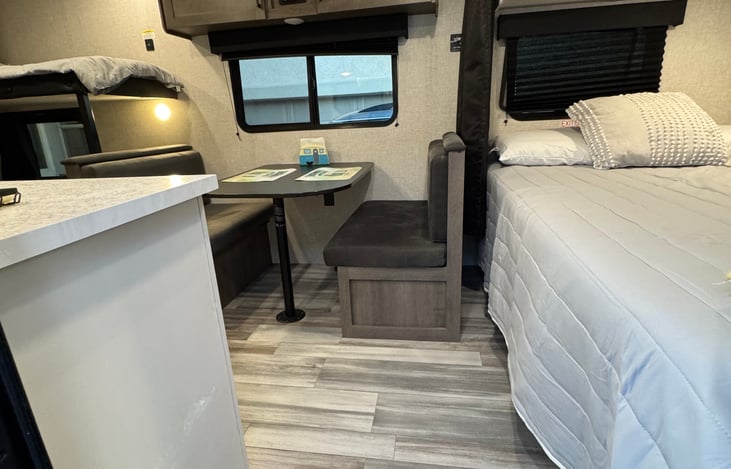 Dinning table turns in to a cozy bed ! It's sturdy and comfortable . Will provide linens as well