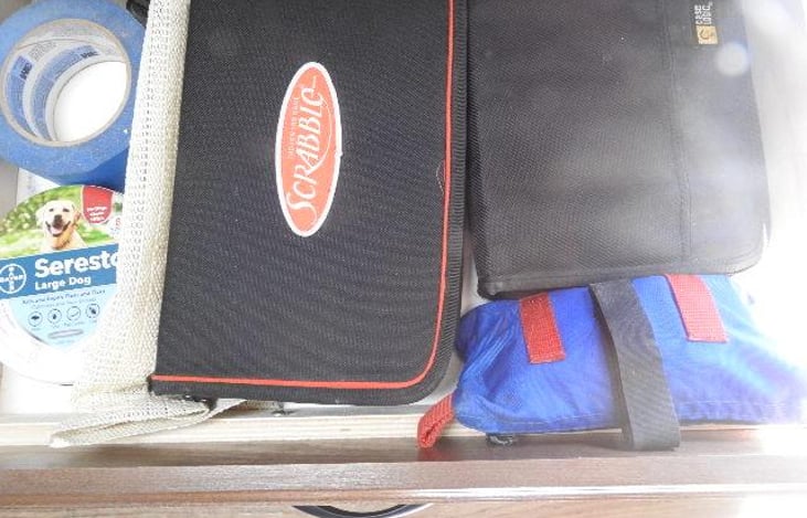 More games and coloring books ,colored pencils ,cards and books , poker chips, CD's, DVD's in upper cabinents .