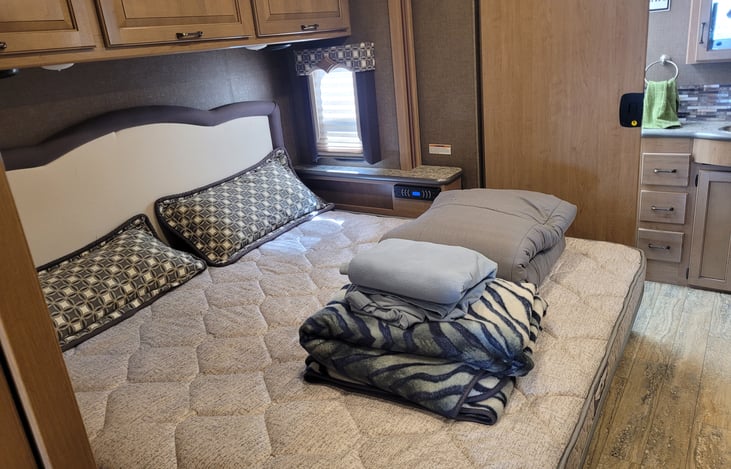 Master bedroom with a king size bed, stereo and TV