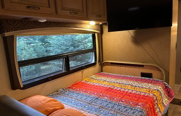 Kitchenette bed, kitchen table lowers providing base for bed.