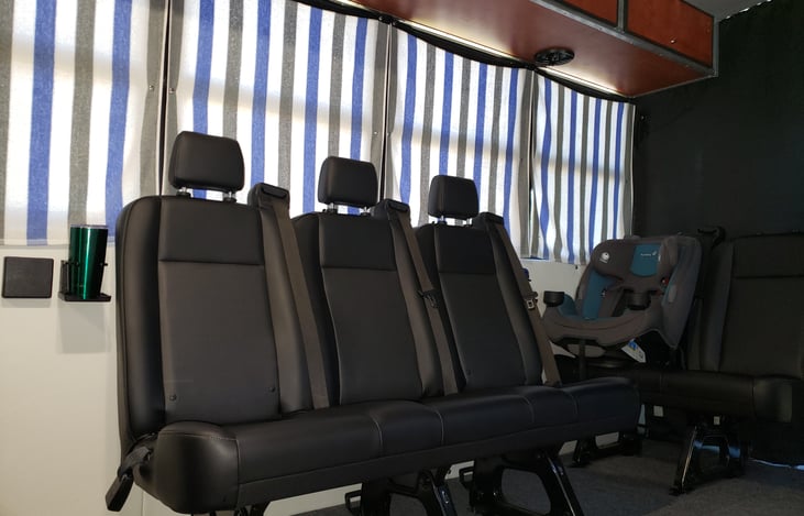 Seating for 15 with seat belts.  Four front facing, four rear facing, six side facing, plus driver.