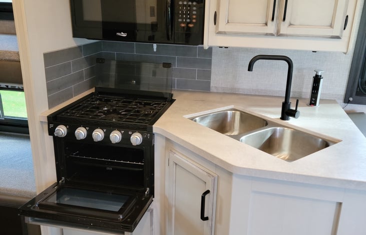 Residential-size microwave + Pop-up charging station with 110 outlet and USB plugs + All-in-one cooktop and oven