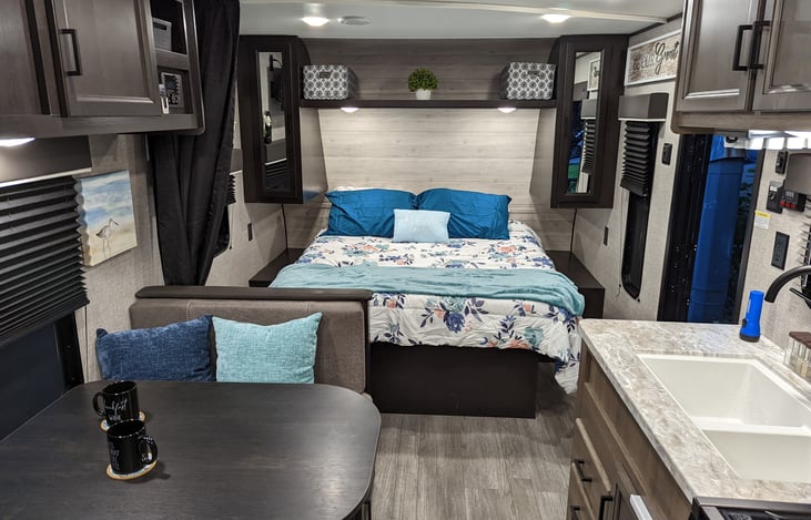 Queen bed with privacy curtain and side storage