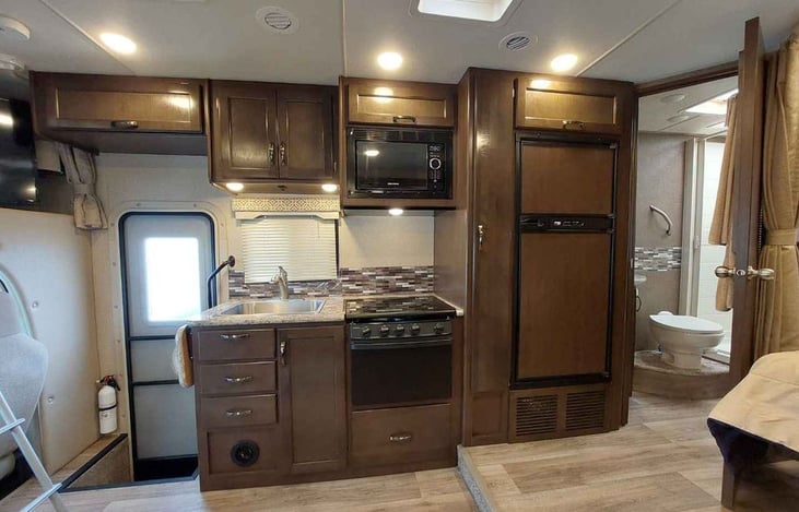 Fully functioning kitchen. Large sized fridge and freezer.  Oven and stove.