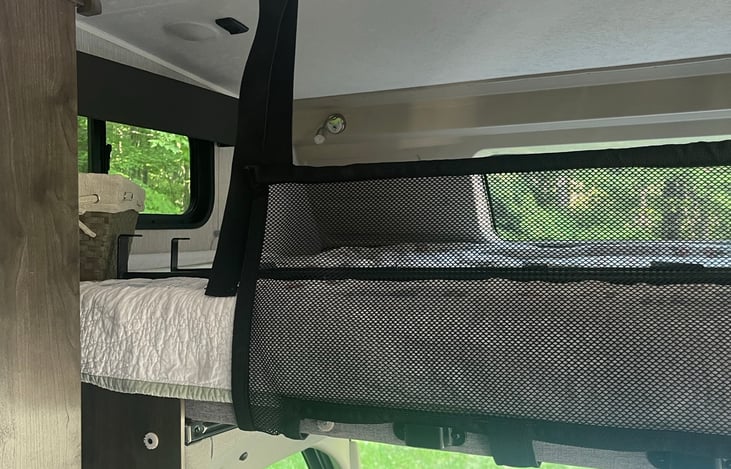 Above cab sleeping area - Queen sized space with memory foam topper for enhanced comfort. Sheets, blankets and pillows provided for all 3 beds.