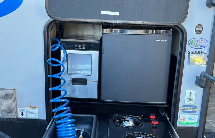 Outdoor kitchen. 2 burners, small fridge and a ice maker for those hot summer days.