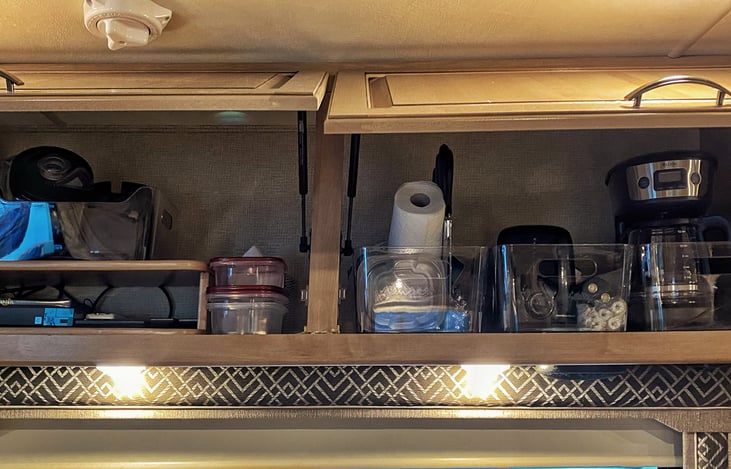 Coffee maker, blender, mixer, toaster, knife set and various kitchenware organized in bins for easy use and noise reduction