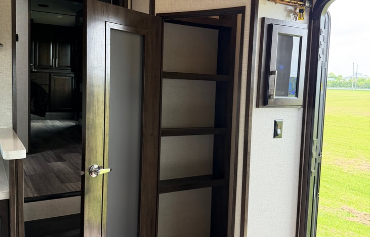 Unmatched Storage: High-end 18 cu. ft. residential Samsung French-door refrigerator paired with a massive walk-in kitchen pantry.