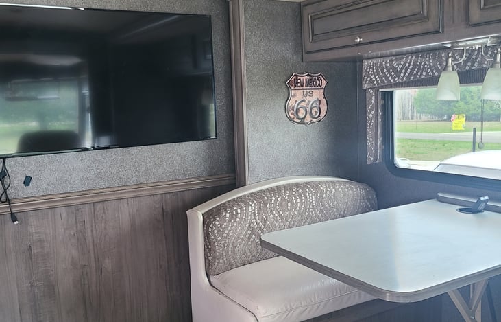 The dining room table lowers to convert into a full bed