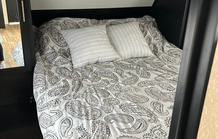 Main bedroom Queen size bed (bedding included) Double side storage and overhead storage