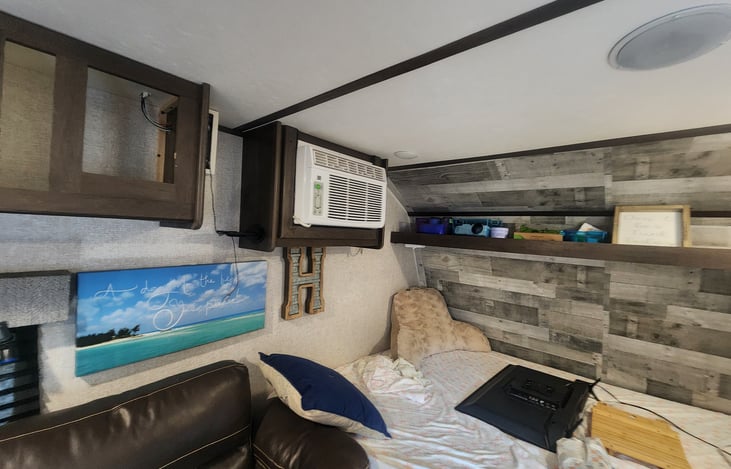 Residential A/C keeps the camper cool on those hot days.  Settable with remote control available.  Bluetooth radio mounted next to it for GREAT sound through the ceiling speakers.