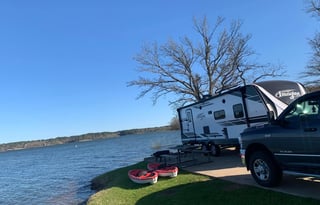 Kayaks, paddle boards, and camper.
