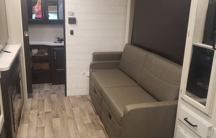 Converts to a couch when the queen bed is up. Storage underneath couch.