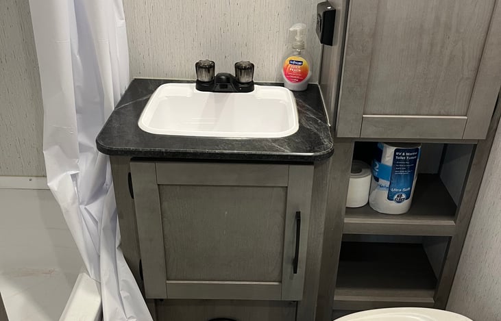 bathroom has a combo tub and shower. Lights come on automatically for late night restroom trips.