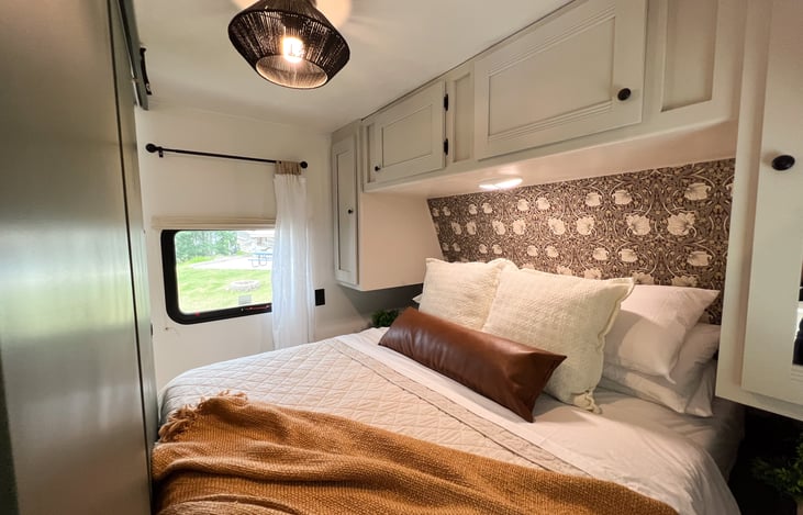 Enjoy a clutter-free space with ample storage in this comfy primary bedroom. Discover the convenience of above-bed cabinetry and under-bed storage, providing a perfect blend of comfort and function.