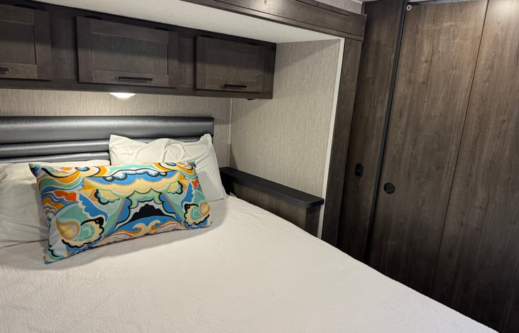 Master bedroom with build in lights over bed and phone charger. Custom cabinets for all your clothes