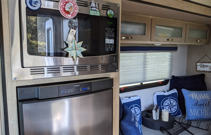 Refrigerator, microwave, and sitting area.