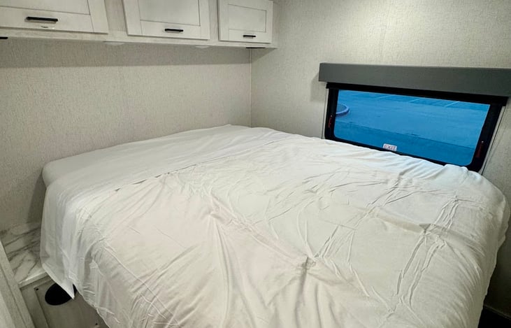 Queen bed in the back of the unit - the mattress has been upgraded from an RV mattress to a full size queen pillowtop. 

It is tighter to move around the bedroom but makes it worth it for a good night