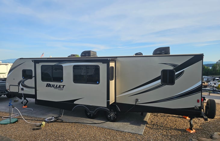Driver's side view of the camper. Image taken at Anchor Down RV Resort in May 2026.