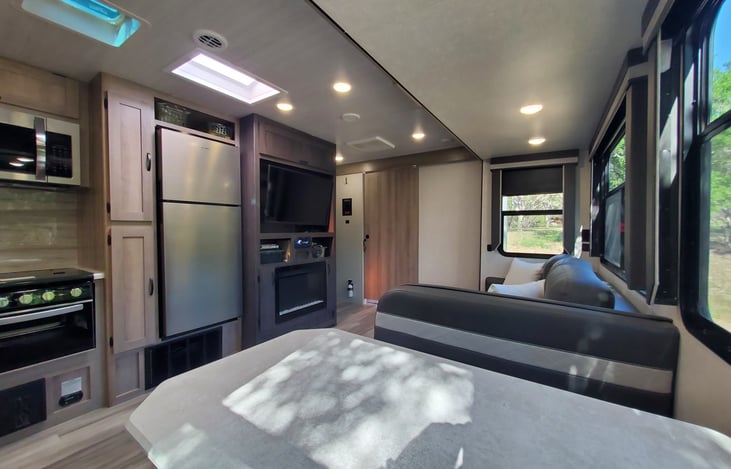 Another view from the corner of the kitchen booth to see how spacious this glamper camper is! Dedicated HVAC for this space.