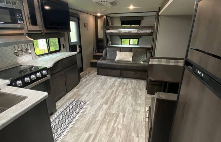double sized bunks at the back have privacy curtains. you can turn the TV so you can watch from bed. closet space for the bunks located above steps. A jackknife sofa that turns into a comfortable bed.