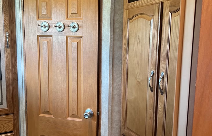 Cabinet and door to the rear half bath