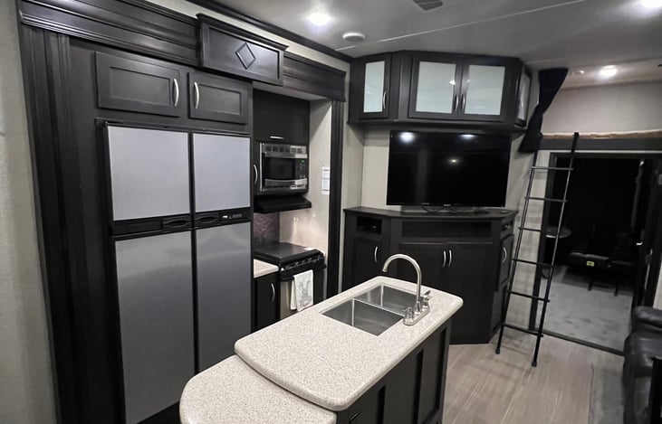 Kitchen with center island oversized refrigerator and freezer. HD tv. Bluetooth radio. Coffee Maker. microwave. two recliners