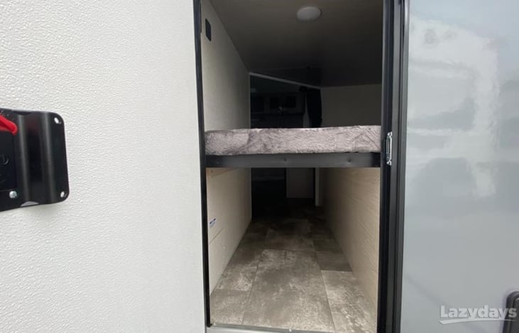 Rear access door to flip-up bottom bunk storage area