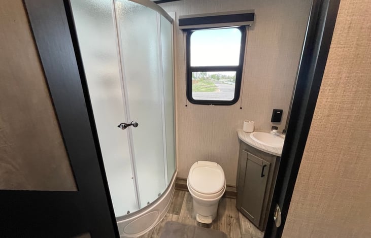 Large shower with tons of storage and vanity