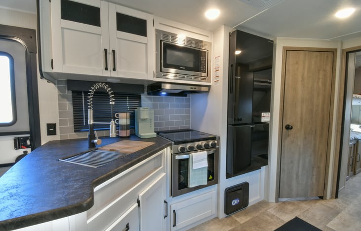 Kitchen comes with coffee maker, toaster, utensils, cup, and dishes