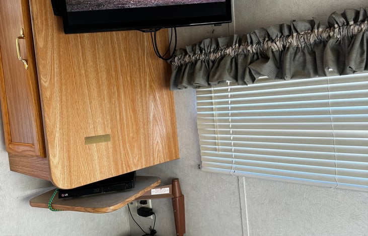 TV above the bed provides endless hours of movies for your entertainment.