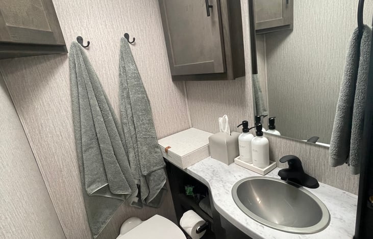 Bathroom (shower separate so others can use toilet while someone is showing.)