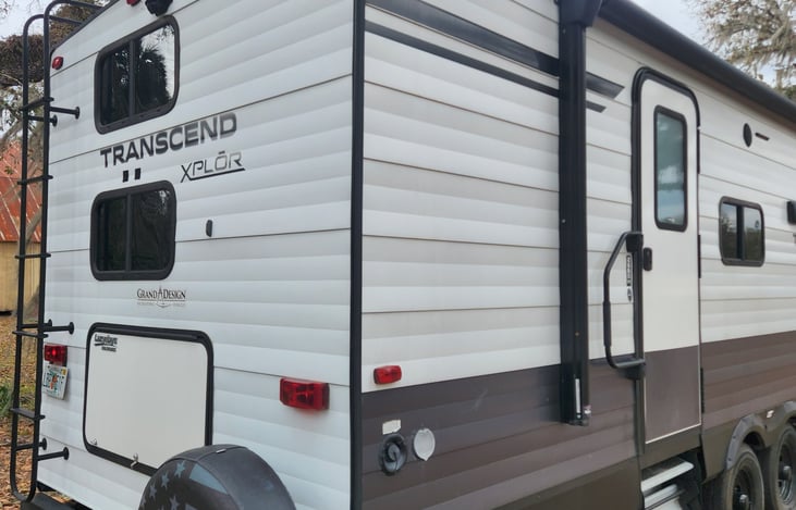 Back right corner.  Rear storage for outdoor equipment.  Rear entry door with stairs and adjustable hand rail.