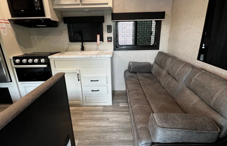 Entering the camper, in front of you is a giant suede couch.