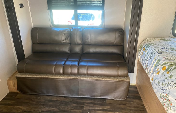 KITCHEN COUCH TURNS INTO SMALL BED.  CAN SLEEP ONE ADULT OR TWO SMALL KIDS.