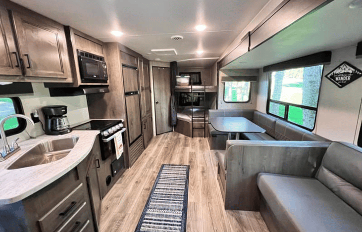 Bottom right of photo: jackknife sofa
Top right: u-shaped dinette and bunks
Too left: bathroom
Bottom left kitchen and entry door