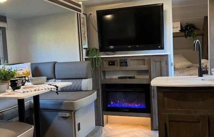 Cozy fireplace/heater with changeable ambient lighting. Bluetooth hookups and radio located underneath TV.