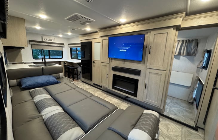 The sofa expands to accommodate sleeping spaces. The door to the slide out shuts for privacy and early sleepers.