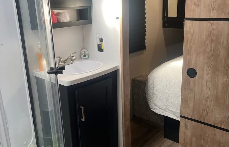 Bathroom includes full size shower, With skylight, vanity and a full size commode.