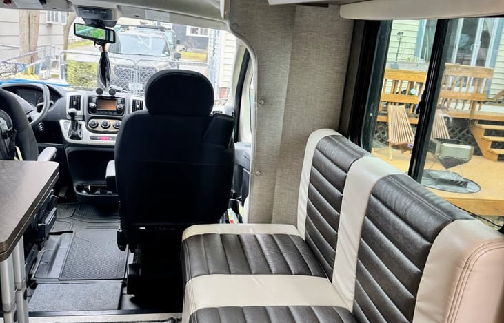 View from the right side of interior. Bench seating around the dinette and plenty of light!
