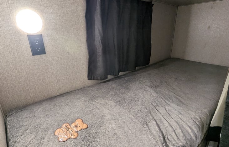 Bottom bunk with 120v a/c plugs.