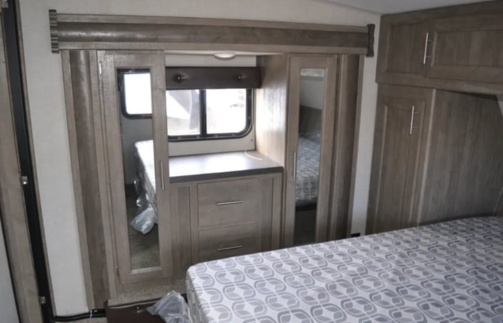 Master bedroom with king bed. Plenty of drawer and closet space. Slide-out allows gor a roomier feel. Access to bathroom from bedroom as well.