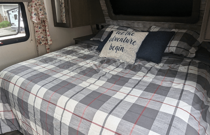 Large front window above king bed. surrounding storage